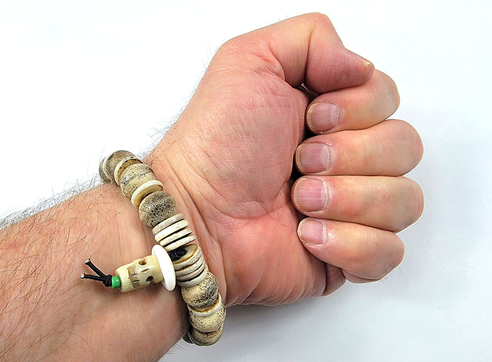 Thumbnail: Bottom view photograph of a man's wrist wearing the Islands To Highlands Cayman Islands Bracelet.