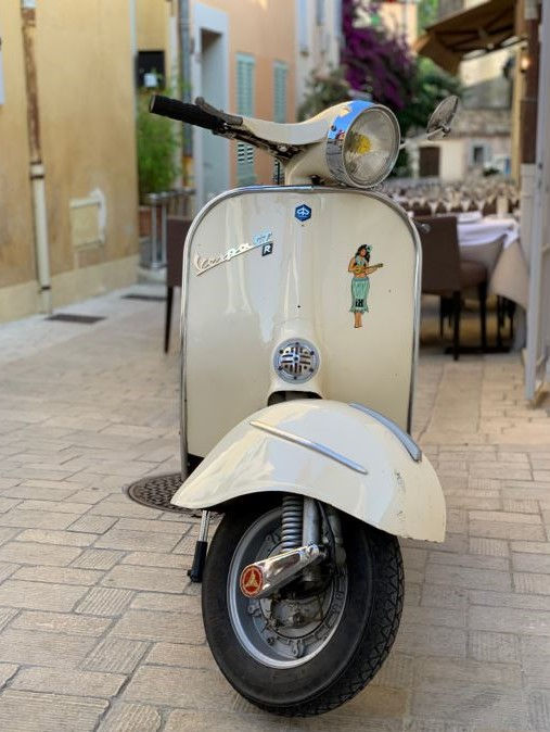Thumbnail: Photograph of the Islands To Highlands iH Hula Girl Magnet on scooter in Spain.