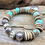 Thumbnail: Photograph of the Yavapai County Bracelet on a piece of driftwood.