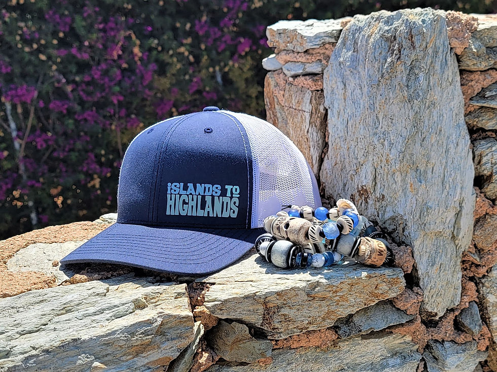 Thumbnail: Photograph of the Islands To Highlands iH Pacific Cap on a stone ledge.