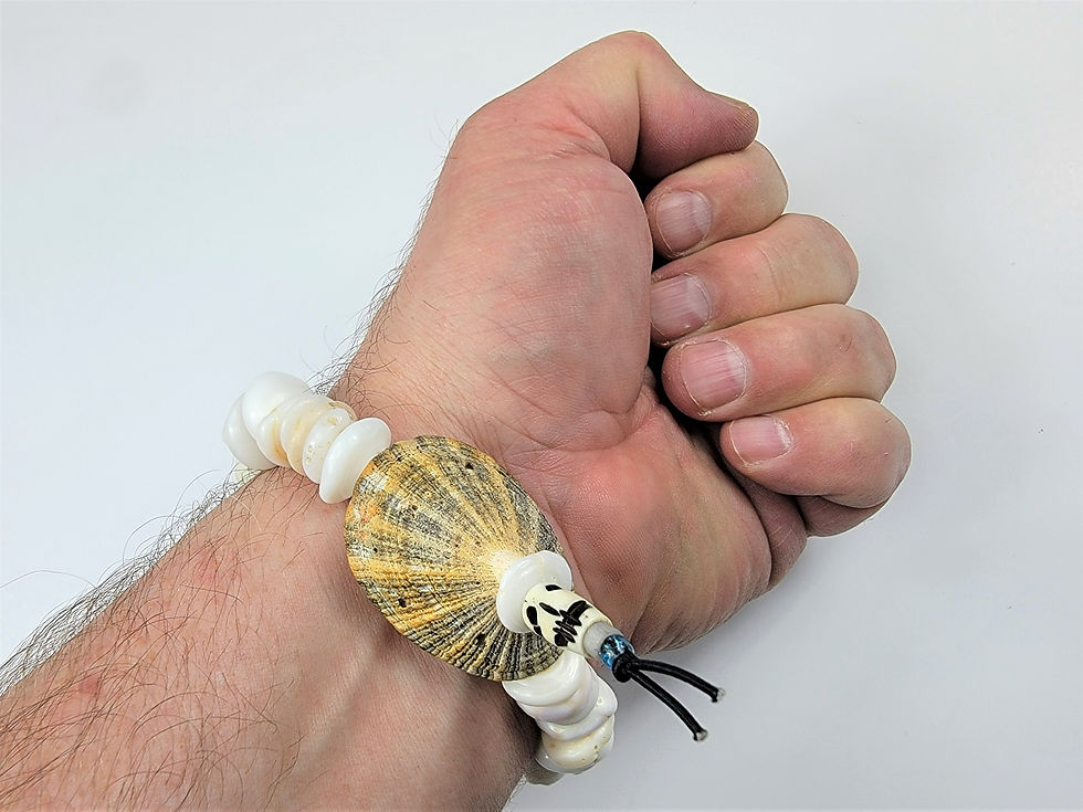 Thumbnail: Bottom view photo of a man's wrist wearing the Islands To Highlands Seashells By The Seychelles Bracelet.