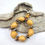 Thumbnail: Photograph of the Islands To Highlands Gun Beach Bracelet on a piece of driftwood.