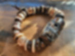 Thumbnail: Photograph of the Islands To Highlands Foix Bracelet on an antique desk.