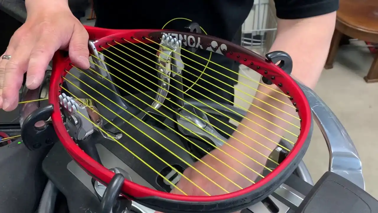 Someone stringing a tennisracket