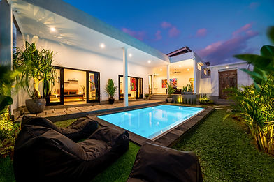 Tropical villa view with garden, swimming pool and open living room