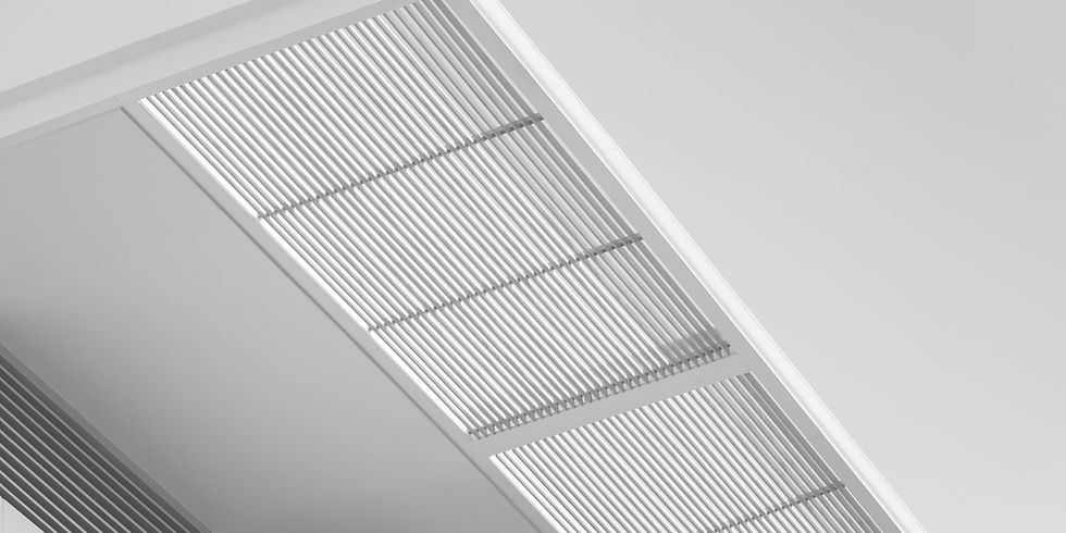 Monochrome image of a modern ceiling with sleek horizontal slats, creating a geometric pattern. Minimalist and industrial aesthetic.