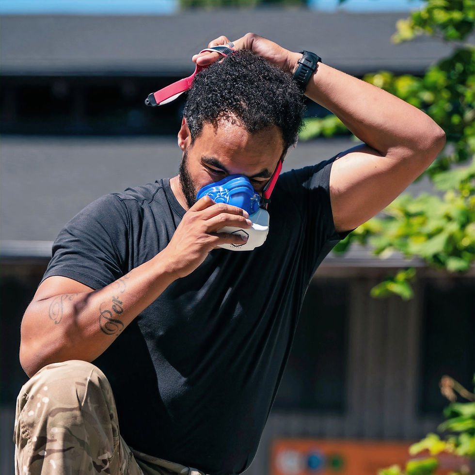 African-American man kneeling and putting on an oxygen mask