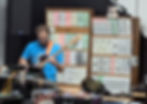 greg performing at synthcube during a boston modular meetup in front of 8 stacked modular synth cabinets.