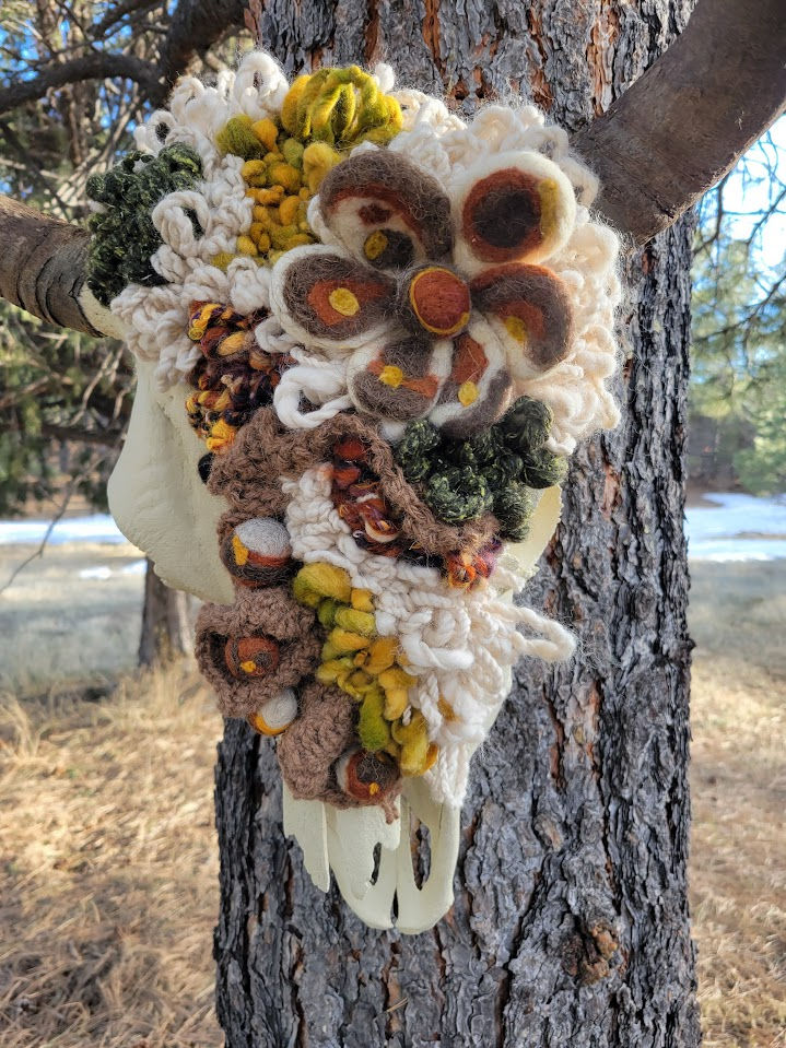 Bison skull adorned in fiber art yarn, camel wool, bison fiber, alpaca. Wall art,