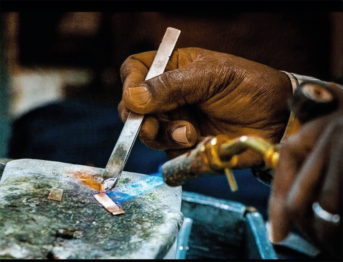 Silver Oak craftsman shaping a 925 sterling silver ornament in the in-house atelier