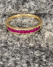 Gold ring with red gemstones, beautifully displayed for sale Thurmont Auction.