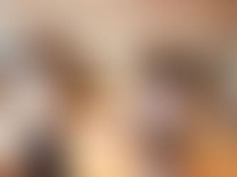 Two women shake hands in a modern office, smiling warmly. A man sits in the background. Stylish decor, neutral tones, bright lighting.