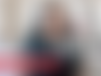 Black woman with long straight hair sitting on a light gray couch in a home office setting, wearing a dark t-shirt. Text overlay reads 'LIFE UPDATE' in large white letters with a red banner below stating '+ my next chapter...