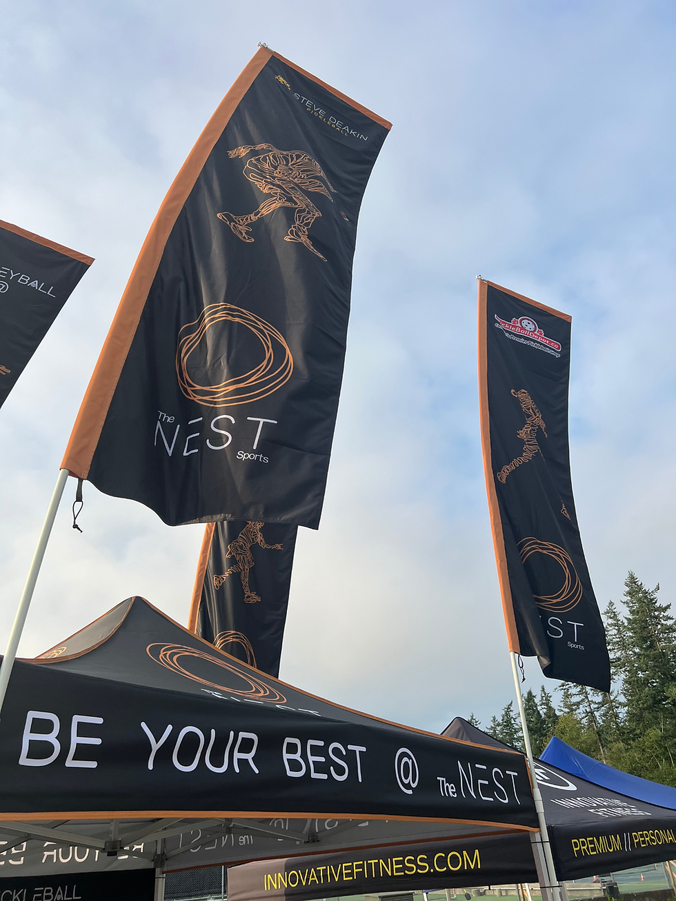 The Nest Sports tent sky flag feature at a pickleball tournament