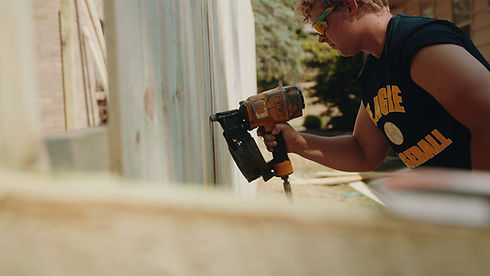 fence builder nailing in fence pickets