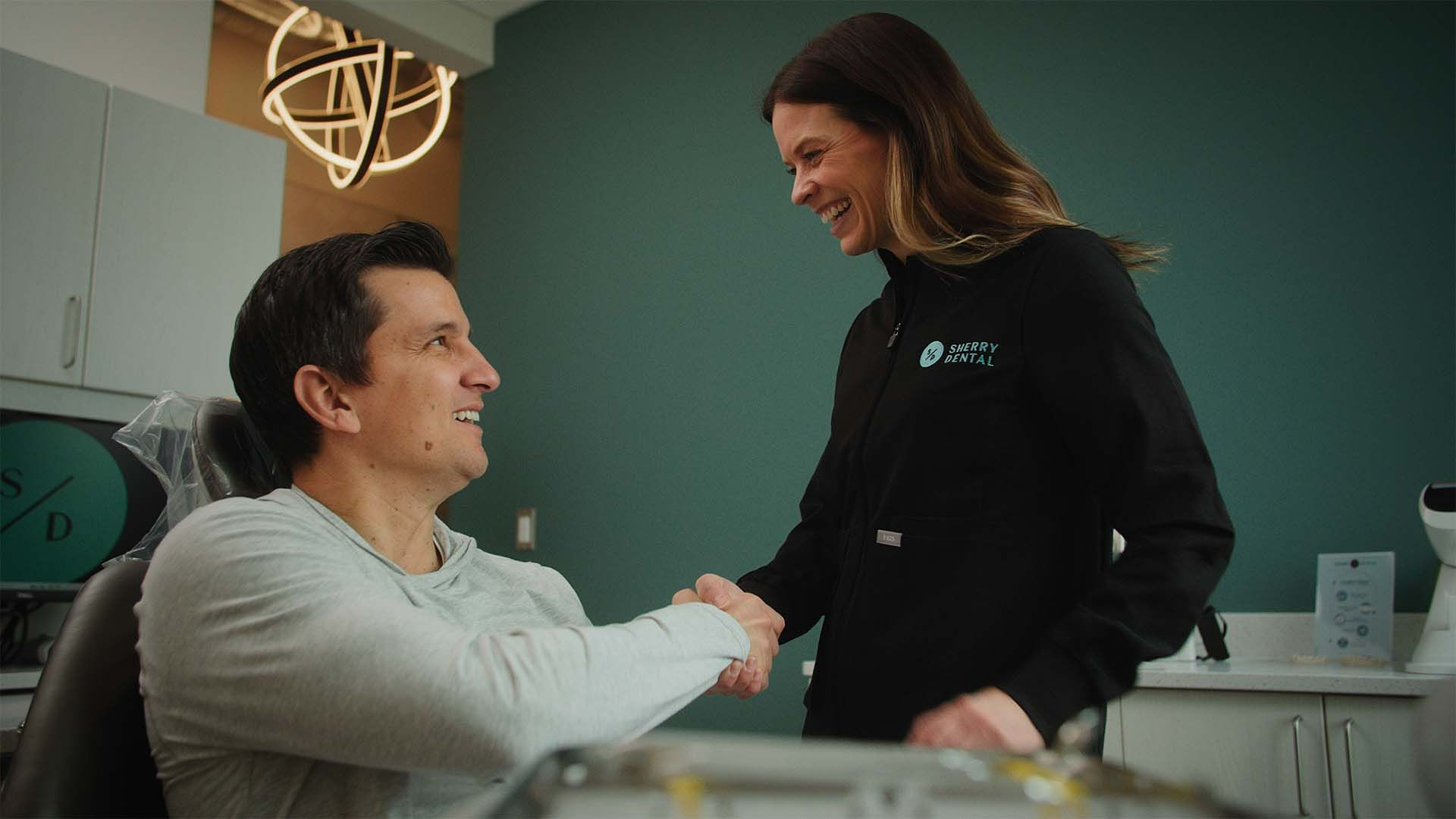 Dr. Sherry of Sherry Dental welcoming a new patient