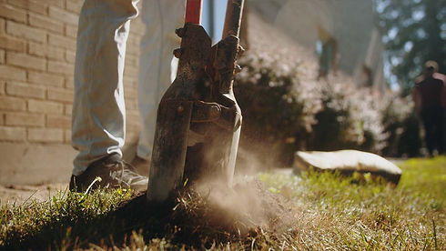 fence builder digging holes with post hole digger tool