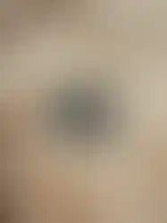 Details of a black embossed QILO x SC Irregulars logo on AOR1 LHTOSE down puffer jacket