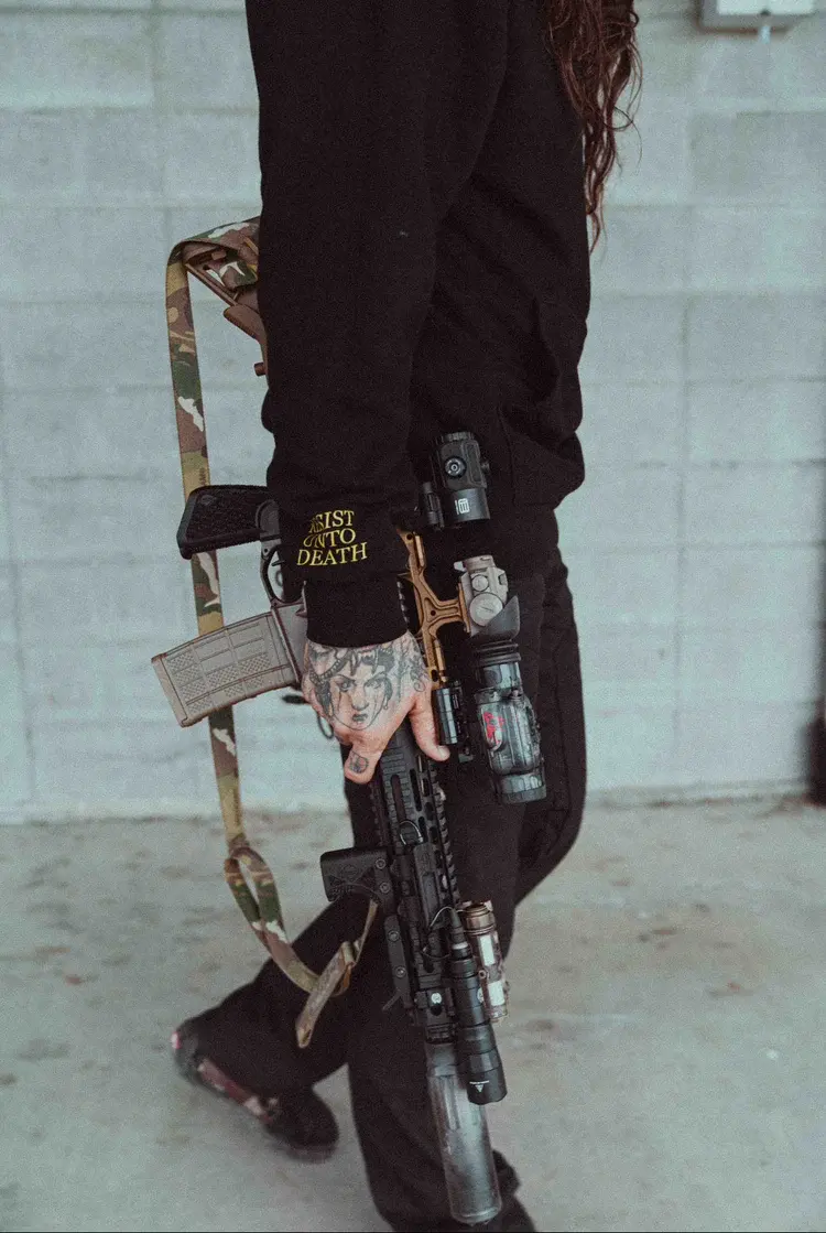 A DEVGRU operator holding a tactical AR15 and wearing a black SC Irregulars CORE V4 Hoodie