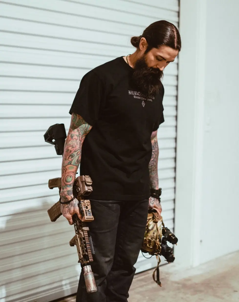 Side profile of a DEVGRU operator, wearing the SC Irregulars TRISAGION S/S shirt and holding an AR15 in his hand