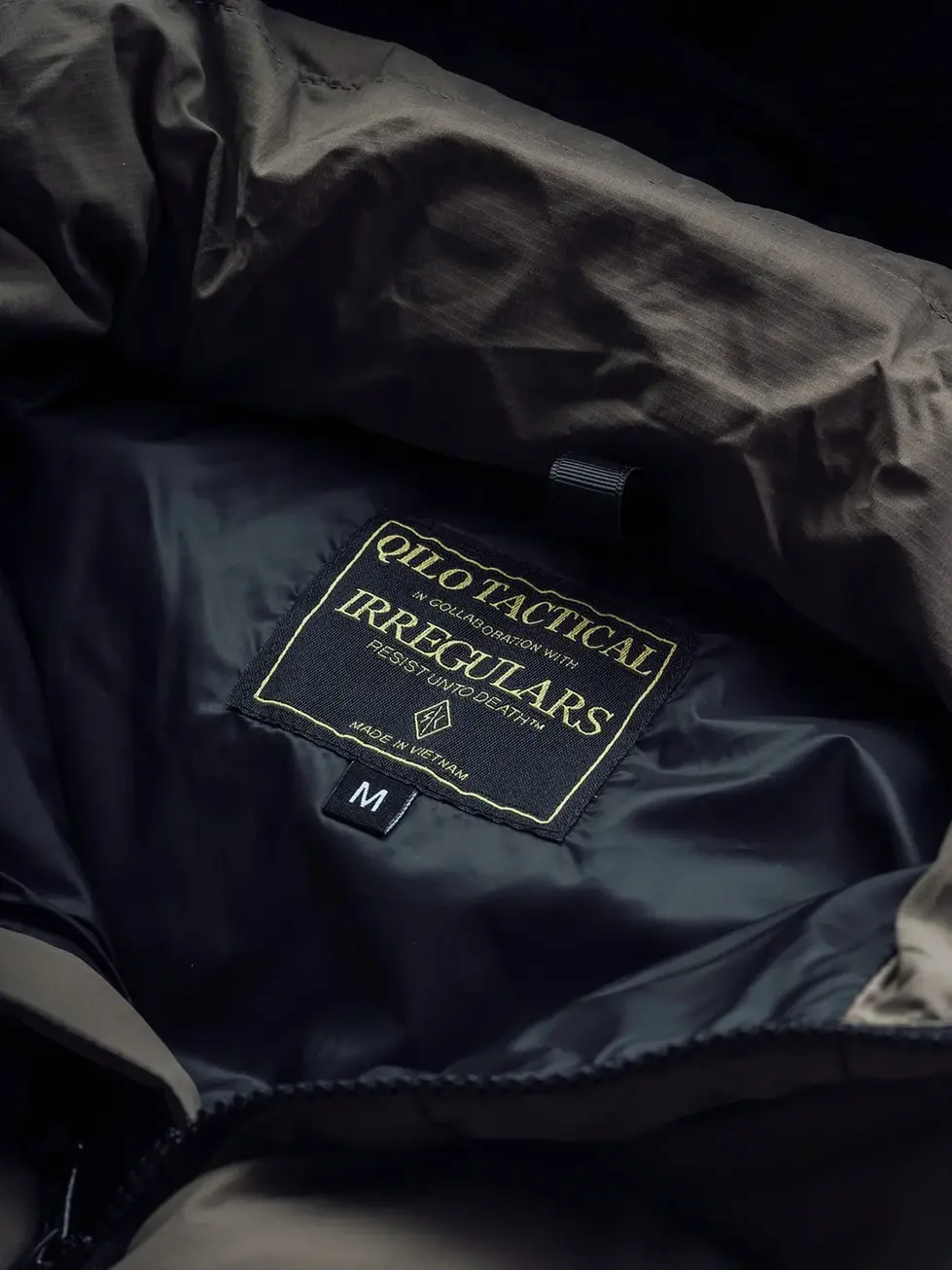 Internal label of QILO x SC Irregulars LHOTSE down puffer in Maritime Grey