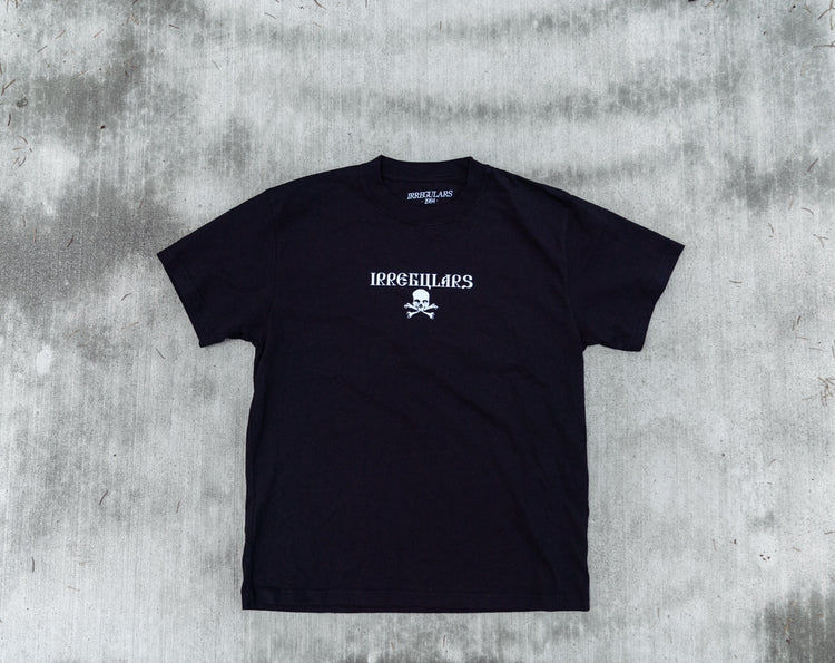 Front view of a SC Irregulars LATER THAN WE THINK S/S shirt, laid out on a grey floor