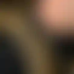 A person wearing a backpack with an attached One Hundred Concepts SlingHook. SlingHook holds a Multicam sling