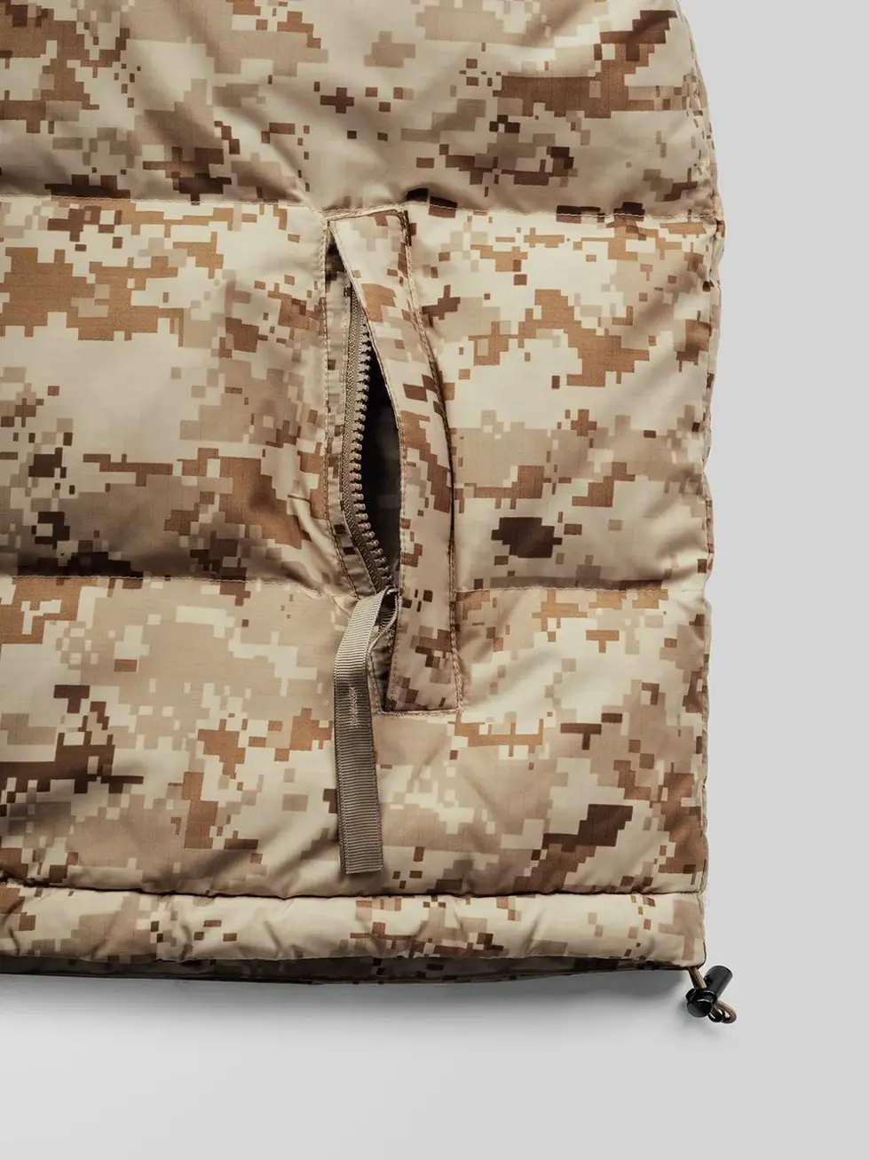 Close-up details of QILO x SC Irregulars LHOTSE down puffer in AOR1, showing details around the zippered pocket