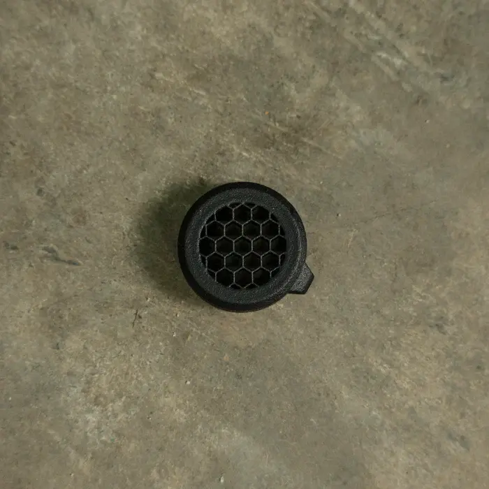 Detailed top view of One Hundred Concepts Aimpoint Micro Series HexCap™ in black color and showing the hex pattern