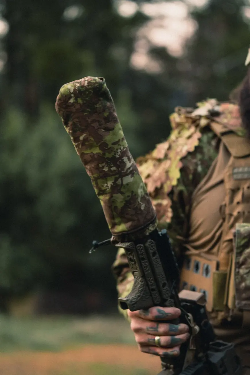Irregular Defense Hot Sock Suppressor Cover in Irregular Disruptive Hinterland mounted on a weapon suppressor.