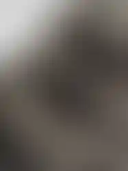 Close-up details of QILO x SC Irregulars LHOTSE down puffer in Maritime Grey, showing the pull tab for adjusting the hood