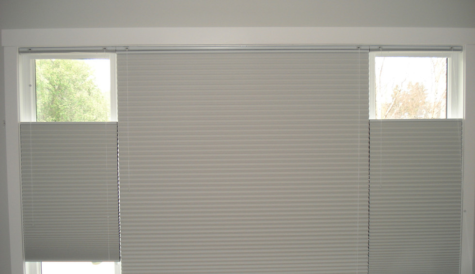 White top-down, bottom-up honeycomb cellulars on bedroom windows