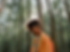 boy looking sad walking through trees
