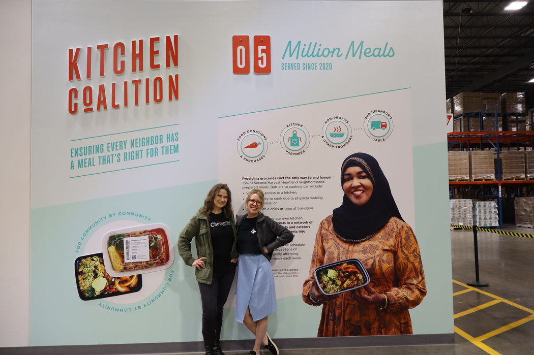 Chowgirls founder and employee celebrating their partnership with the local food relief organization Kitchen Coalition.