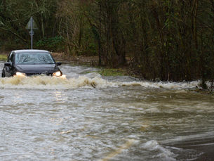Car driving through storm waters
