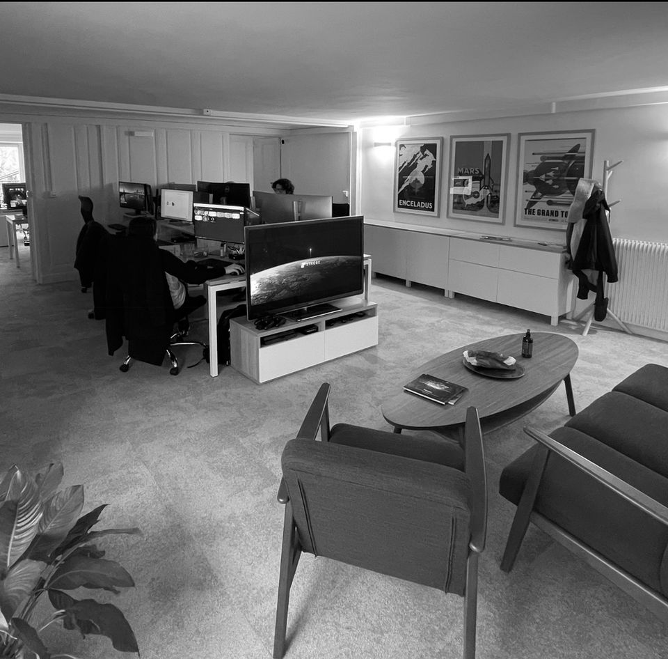 Modern office setup with seating, desks, and artwork ABOUT STROBE Studio.