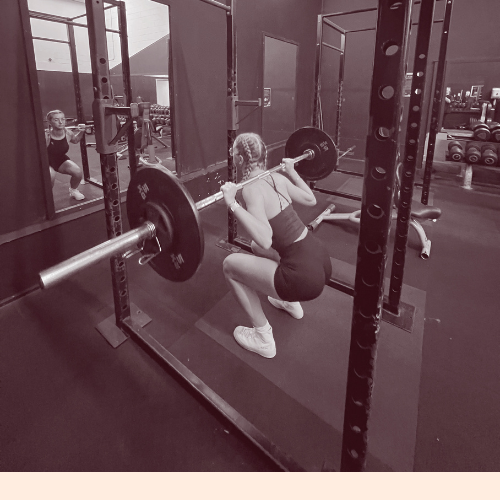 Image shows a female doing a weighted squat
