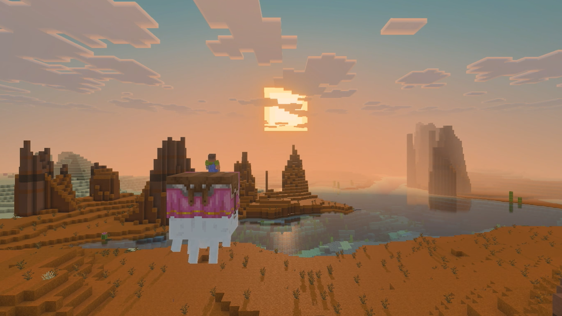 Minecraft Nintendo Switch 2 screenshot showing a player character riding a llama through a mesa desert landscape at sunset with a large body of water in the background