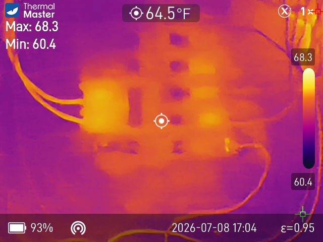 Infrared thermal image of an electrical panel showing temperature differences among breakers during a home inspection.
