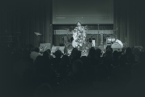 Female singer performing ROCK N SOUL concert for an audience.