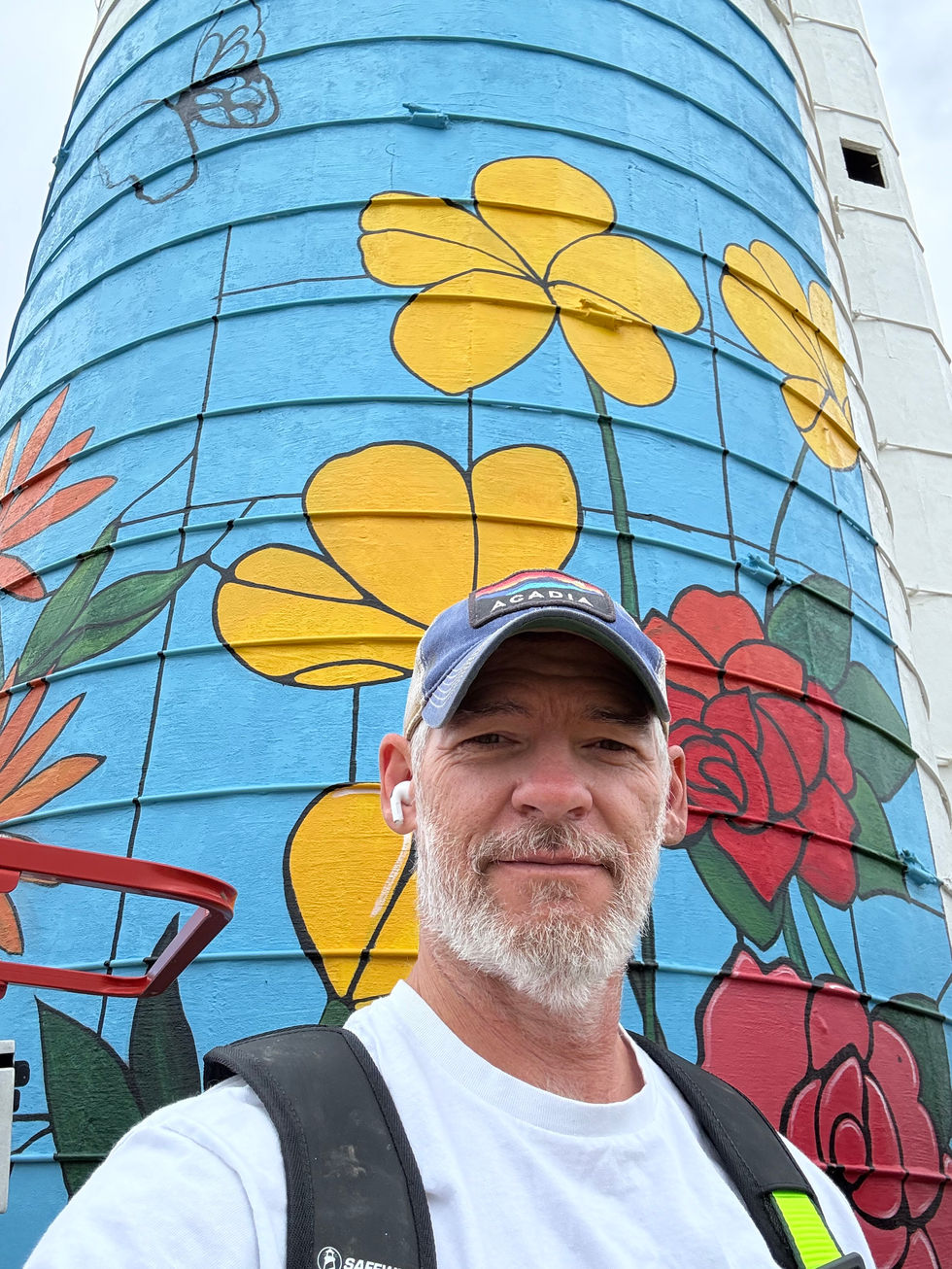 the artist in the midst of painting a mural