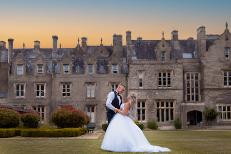 A lovely twilight portrait of a couple at Shendish Manor, with the evening sky adding a dramatic touch