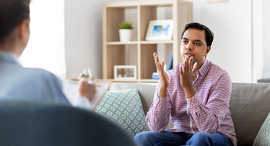 psychology, mental therapy and people concept - young indian man patient and woman psychol