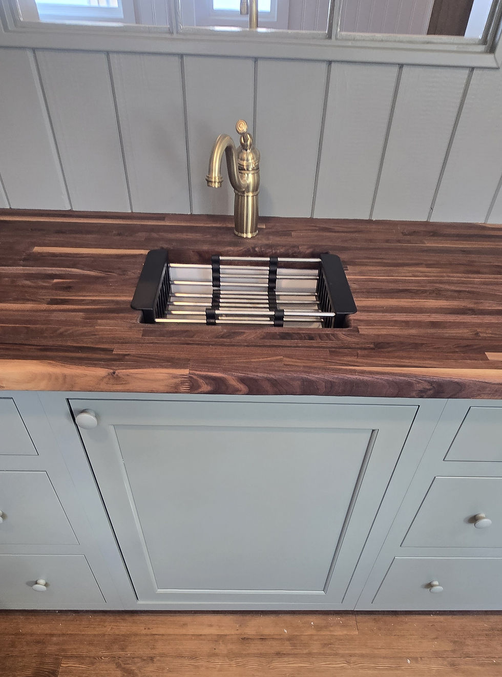 Close-up view of sink with golden spout