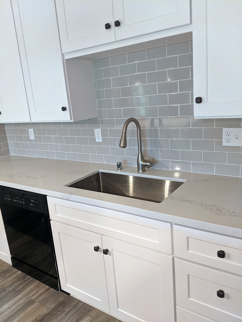 Modern metal sink in quartz countertop