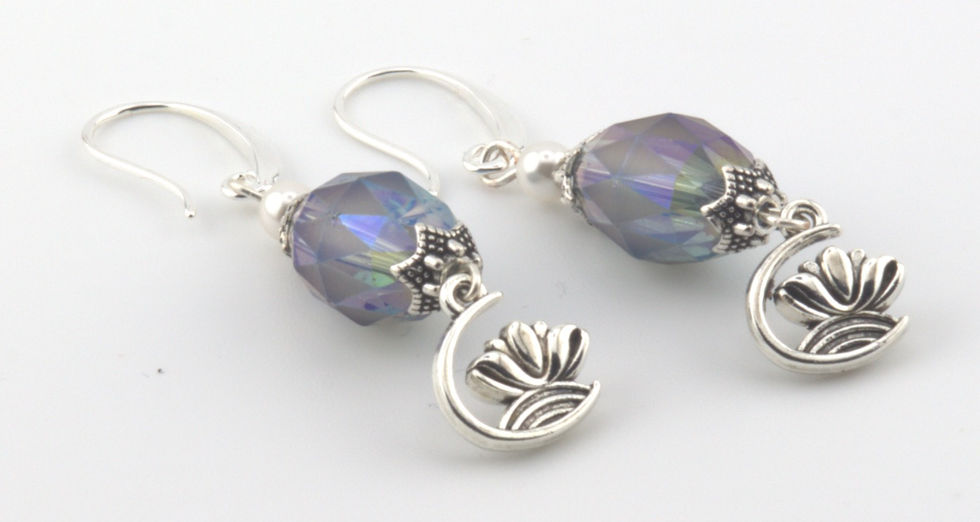 Lotus Flower Earrings with Austrian 4mm round crystal pearls in white Crystal faceted oval beads (12x9.5mm) in peacock blue, and dangling silver-colored lotus flower. 