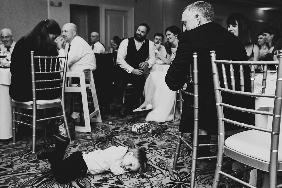 Reception guests celebrate as a child joins the dancing