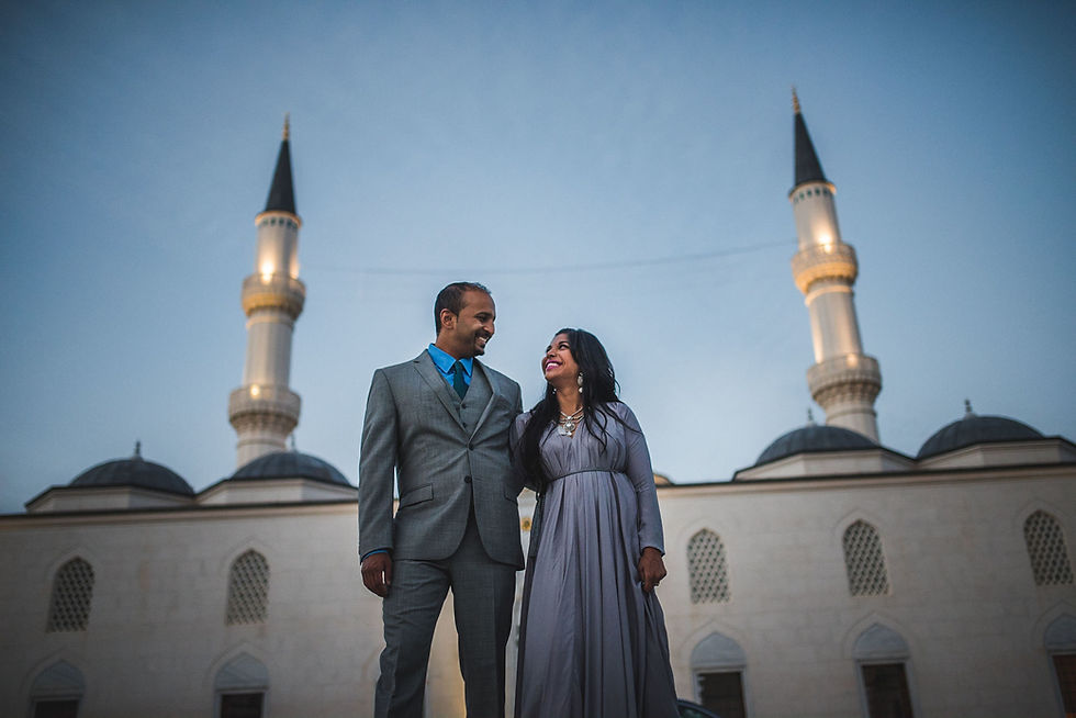Couple smiling at each other in front of the Diyanet Center mosque and its two minarets
