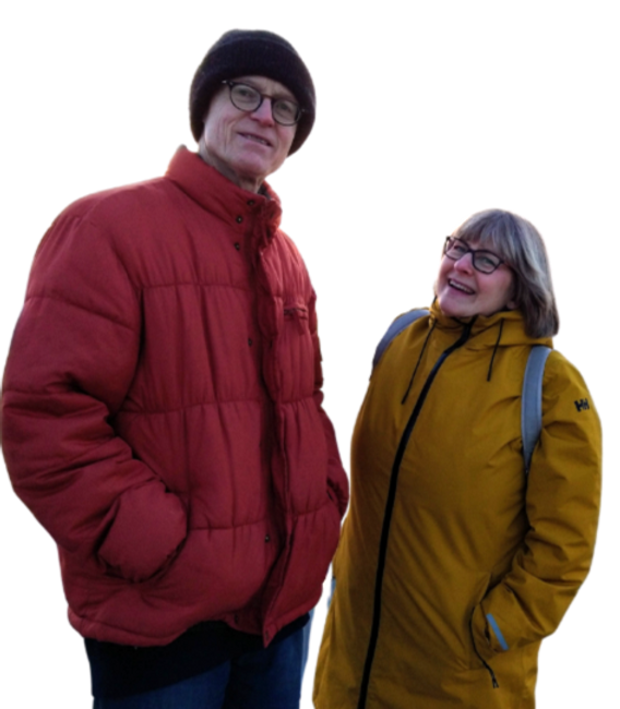 Tall man on the left wearing a red jacket and a shorter smiling woman in yellow on the right