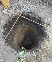 This hole shows a layer of clay under the topsoil in our backyard
